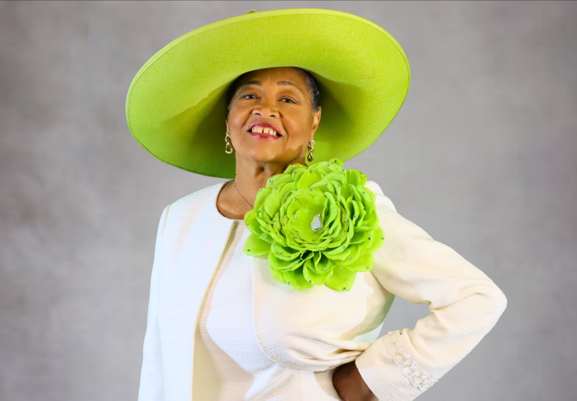 Dr. Pamelia R. Hunter, First Lady & Community Educator - Elegant portrait in white outfit with lime green hat
